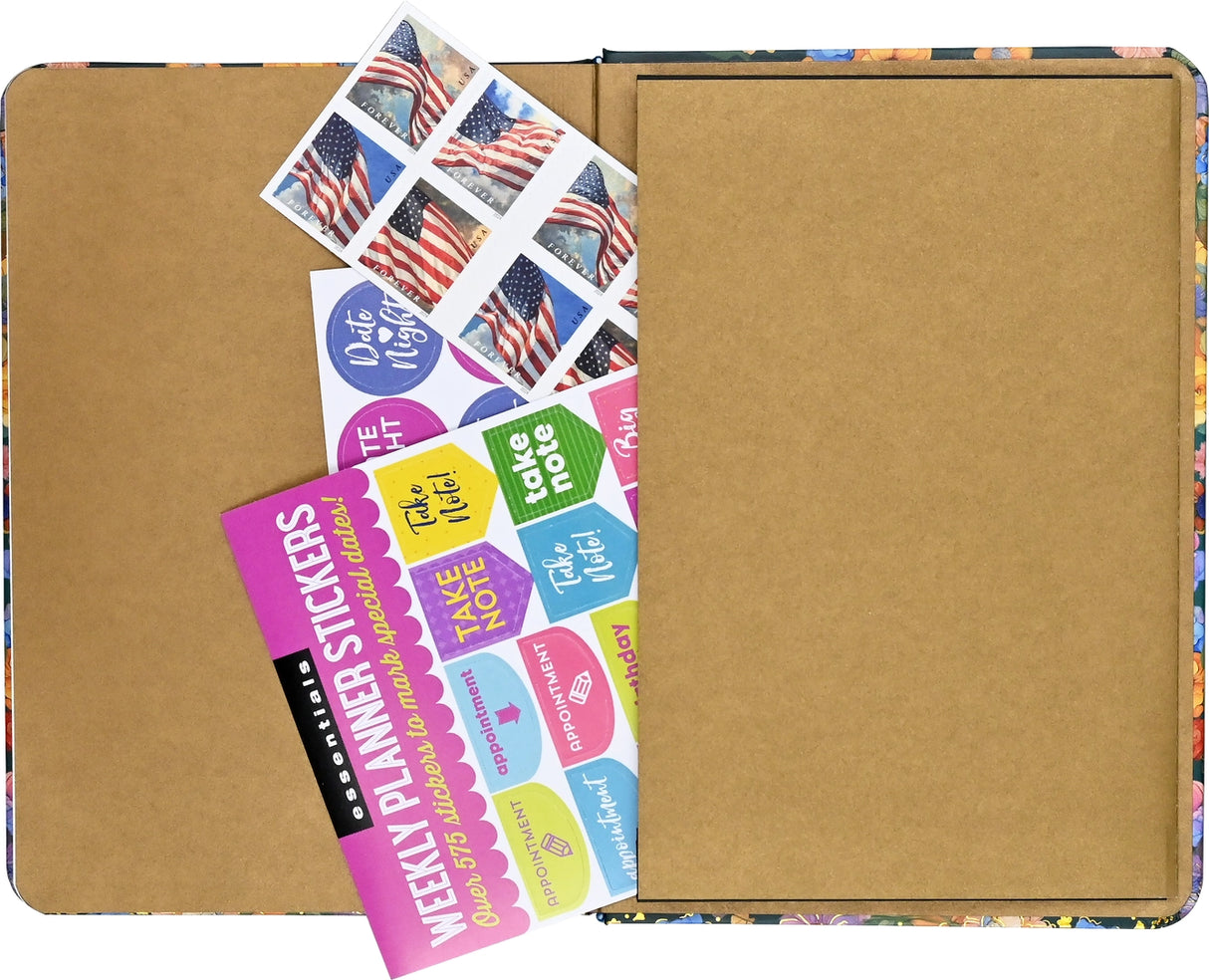 Open Highland Cow Journal showing back pocket holding colorful planner stickers and stamps on brown paper lining