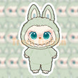 Cute Labubu character wearing a pastel green fuzzy animal costume with big blue eyes and playful expression sticker design