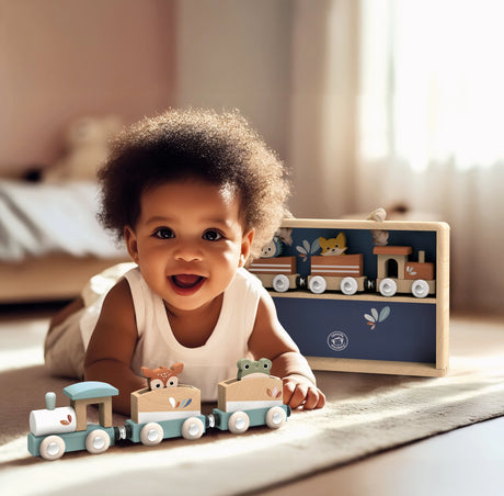 Toddler smiling and playing with a wooden train set and animals on a soft carpet in a bright room