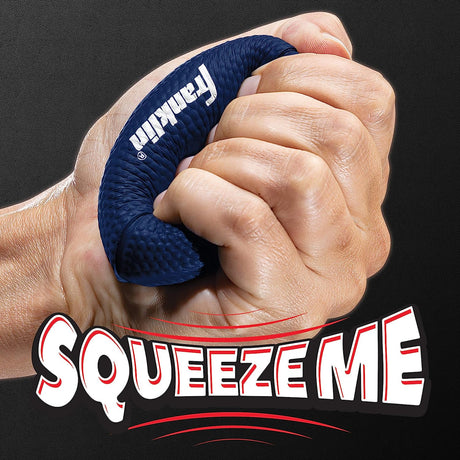 Hand squeezing a navy blue Patriots Football Stress Ball made of soft, durable foam for stress relief.
