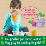 Young child stacking colorful numbered pots while playing a vegetable garden game to build motor skills