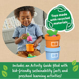 Child playing with colorful vegetable garden toy made from recycled materials, learning counting and colors with pots numbered one and two