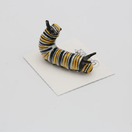 Critterz Jojo Monarch Caterpillar miniature porcelain figurine with detailed yellow and black stripes on a white card.