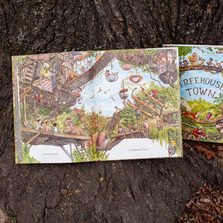 Open pages of Treehouse Town show detailed illustrations of a vibrant treetop world with children and animals exploring.