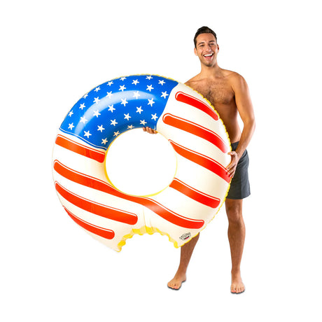 Man holding patriotic Pool Float | Americana Frosted Donut with red, white, and blue stars and stripes design.