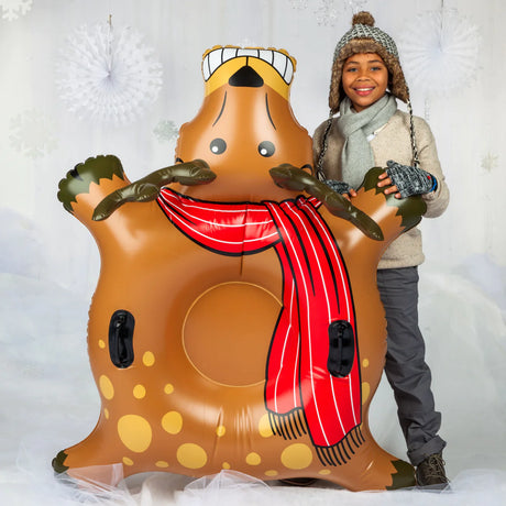 Snow Tube | Rad Reindeer inflatable snow tube with grip handles, held by smiling child in winter clothes.