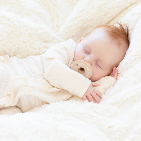 Sleeping baby peacefully using Pacifier | Cheeks for Weeks made of soft silicone for comfort.