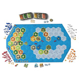 Board game setup for Catan Explorers and Pirates Expansion 6th Edition with tiles, cards, and pieces on a blue hex map