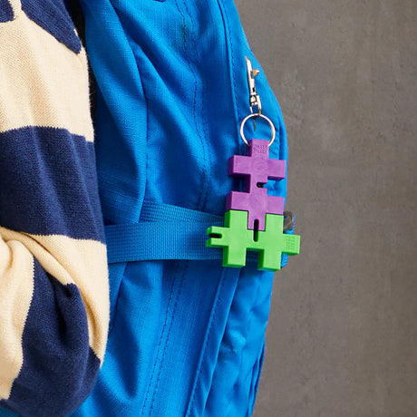 HEXEL Duo Keychain attached to backpack, colorful durable fidget toy for stress relief and focus, designed for all ages.