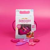 Mini Sensory Jar | Pink packaging with pink sensory fidget pieces displayed on a bright pink background
