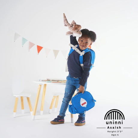 Toddler Lunchbag | Shark in blue with shark design, insulated and kid-friendly, held by a smiling child with a toy.