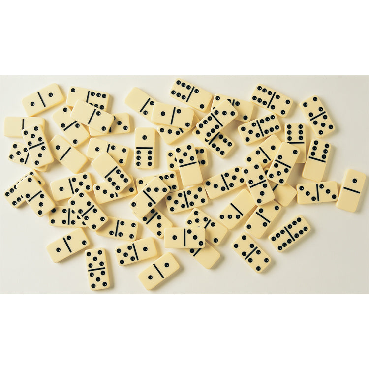 Scattered classic domino tiles with black dots on a light background ready for family game time or friendly competition