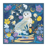 500 piece celestial owl puzzle featuring a white owl surrounded by colorful flowers and a lantern on books