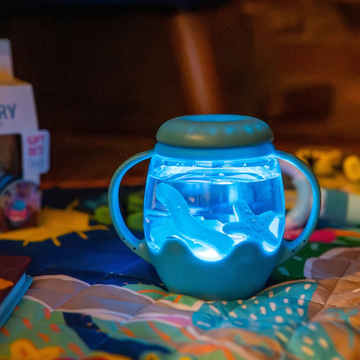 Mini Sensory Jar | Blue glowing sensory jar with handles and floating shapes