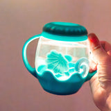 Mini Sensory Jar | Blue glowing sensory jar with flower and ring shapes held in a hand