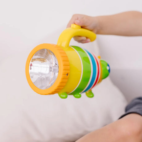 Child holding colorful Flashlight Giddy Buggy with sturdy handle and bright light for kids' nighttime adventures