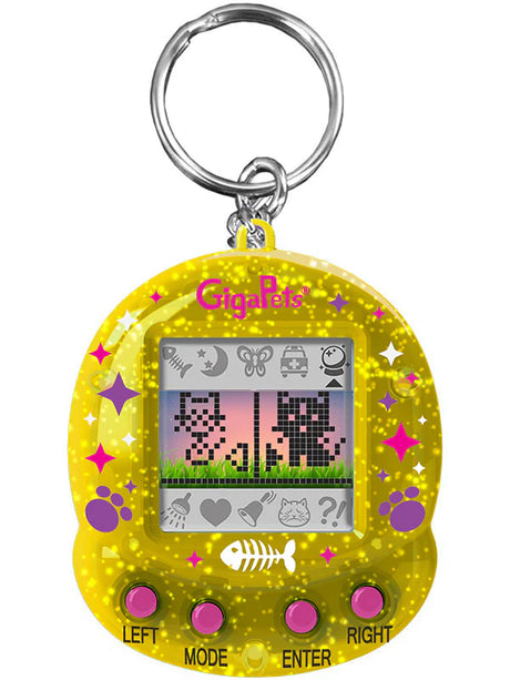 GigaPets Starcat Compukitty virtual pet toy with yellow glitter case and pixelated cat characters on screen.