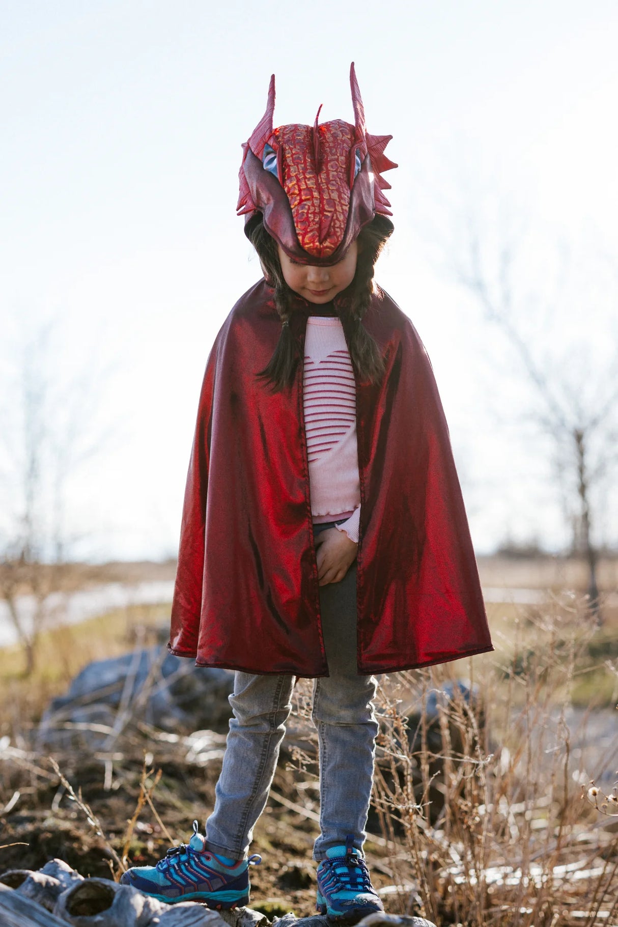 Ruby the Metallic Dragon Cape Size 5-6 worn by child outdoors, vibrant red with dragon head and scale details.