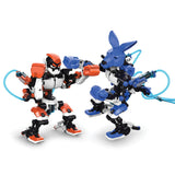 Two colorful hydraulic boxing robots face off in a playful fighting stance against a white background