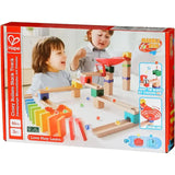 Children playing with colorful Crazy Rollers Stack Track Marble Run blocks and marbles on a white surface