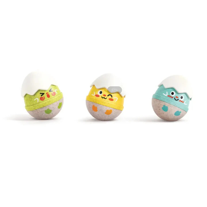 Set of three colorful baby wobble rattles shaped like cheerful hatching eggs with playful facial expressions