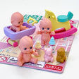 Japanese baby room toy set with miniature dolls, rocking horse, bathtub, bottles, and small animal figures on blister card.