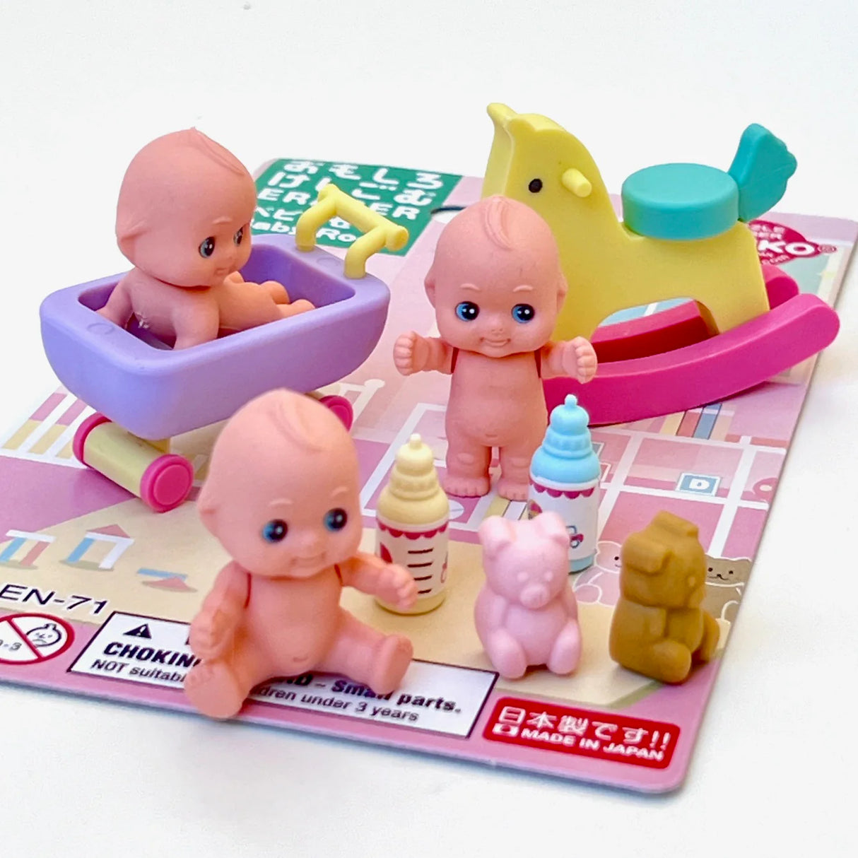 Japanese baby room toy set with miniature dolls, rocking horse, bathtub, bottles, and small animal figures on blister card.