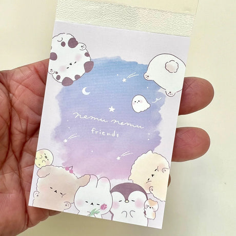 Mini Notepad | Nemu Animal Friends showing colorful cute animal designs and night sky background in hand.