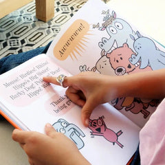 Person reading an illustrated animal book with colorful cartoon animals and rhyming text