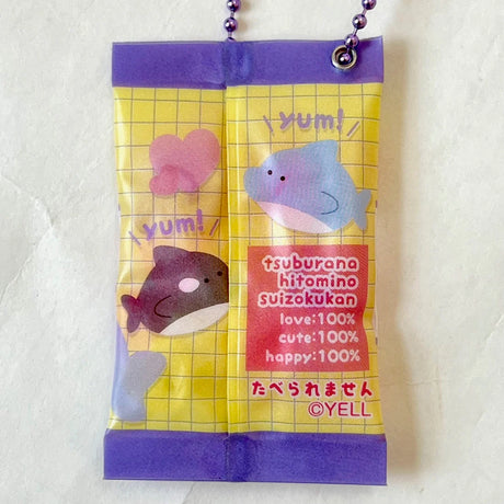 Gummy Shark Keychain resembling a tiny colorful gummy bag with cute fish and "yum!" text design.