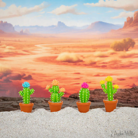 Itty Bitty Cactus set with colorful flower-topped soft vinyl potted plants in desert scene, no watering needed.