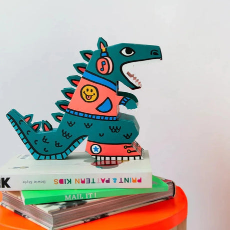 3D DIY Lamp | Dino showing colorful, assembled dinosaur model standing on stacked books, perfect as a creative night light.