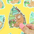 Love the Forest Bigfoot Sticker showing a happy Bigfoot hugging a tree with forest greenery background.