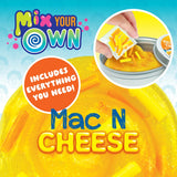 Bright yellow Mac N Cheese thinking putty with mix-in pieces being added from a package into a tin container.
