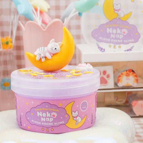 Neko Nap Cloud Creme Slime with a sleeping cat on a crescent moon lid, scented with calming lavender for relaxation.