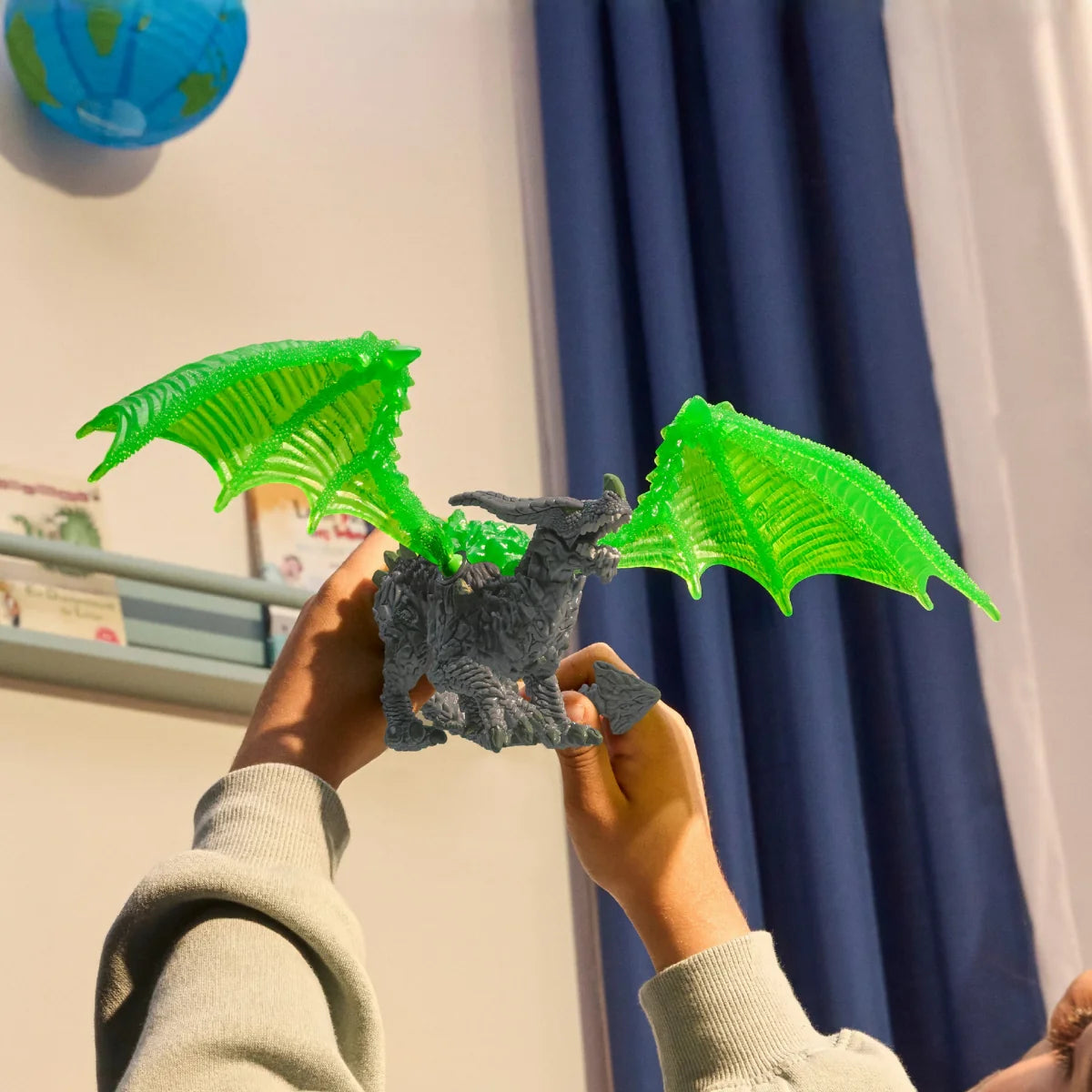 Eldrador Creatures | Rock Dragon with bright green wings held up for display