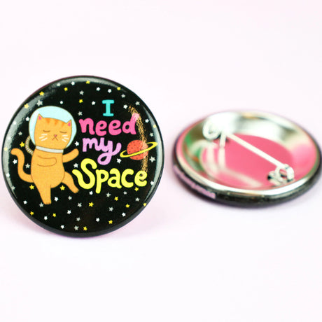 I Need My Space Cat Button with cute astronaut cat and colorful text on black starry background pin back button