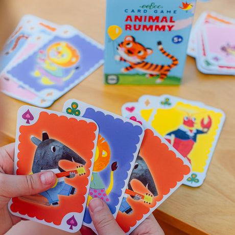 Animal Rummy deck showing colorful animal illustrations and a box with vintage-style design for kids 5+ years.