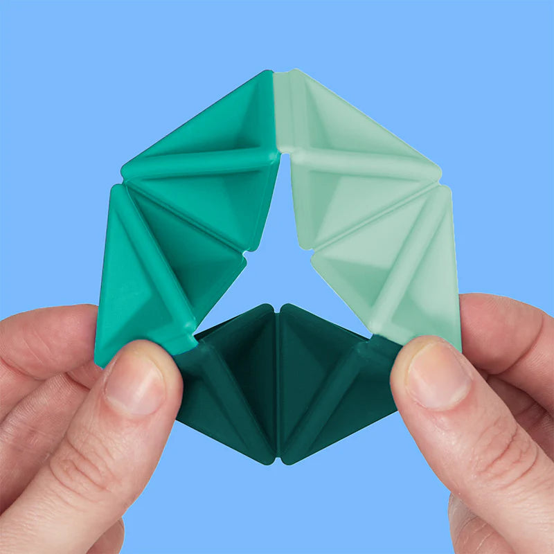 Speks. Pivot. Colorful silicone geometric fidget toy held in hands