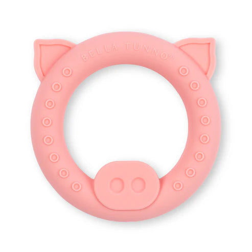 Soft pink pig-shaped baby teether rattle designed as a baby’s first toy with textured grip areas