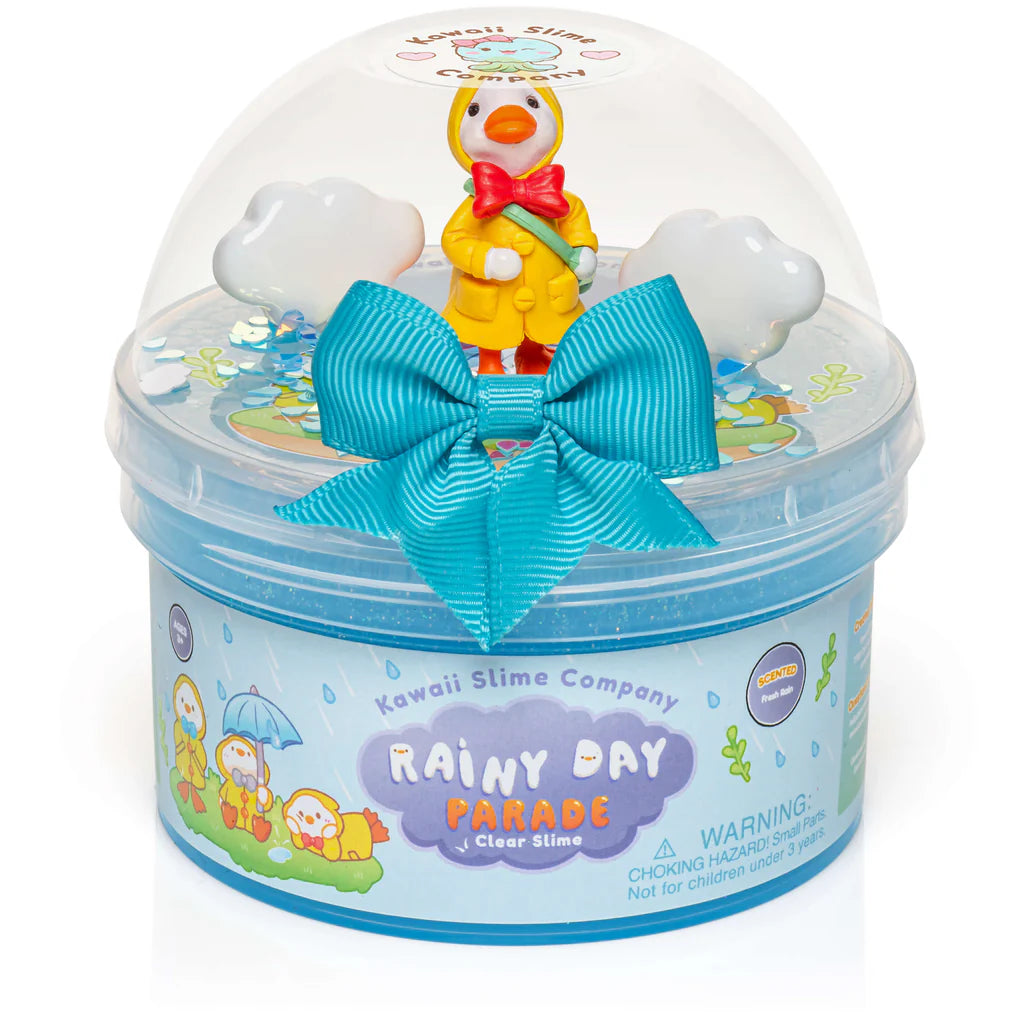 Rainy Day Parade Clear Slime with glittery blue slime, trenchcoat duck charm, and cloud confetti in clear dome packaging.