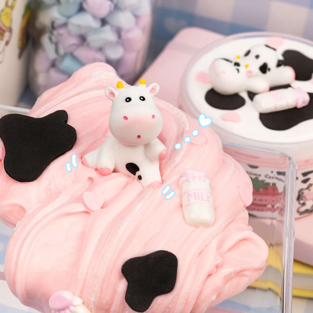 Straw-Dairy Cow 2 Slimes in 1 with glossy pink slime, clay cow topper, and milk bottle detail.