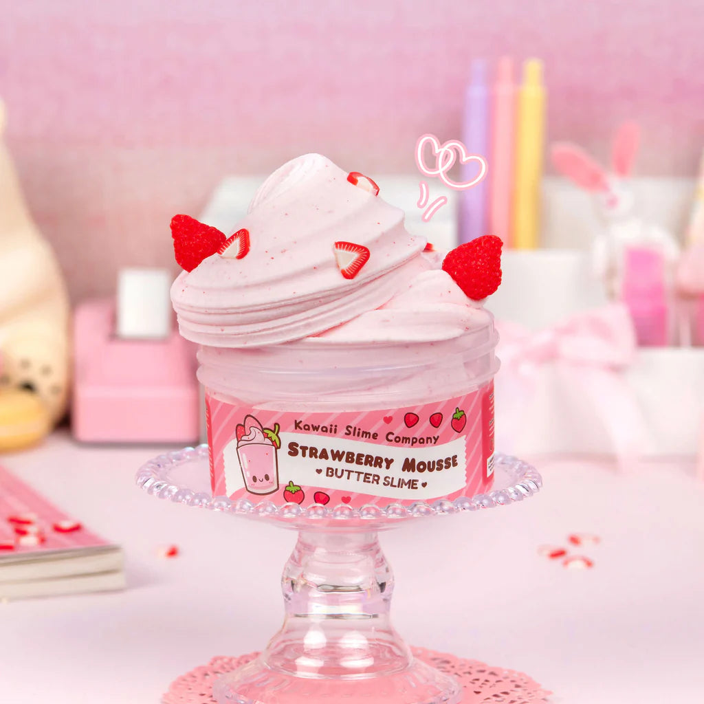 Strawberry Mousse Butter Slime in a jar with creamy pink texture and strawberry charms on top, soft and stretchable slime.