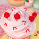 Strawberry Mousse Butter Slime with creamy pink texture and strawberry charms on top, resembling fluffy mousse dessert.