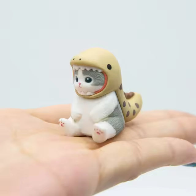 Mofusand figure dressed as an eel, sitting in the palm of a hand.