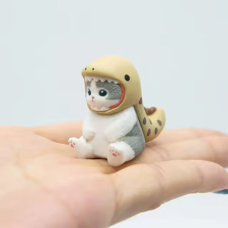 Mofusand figure dressed as an eel, sitting in the palm of a hand.