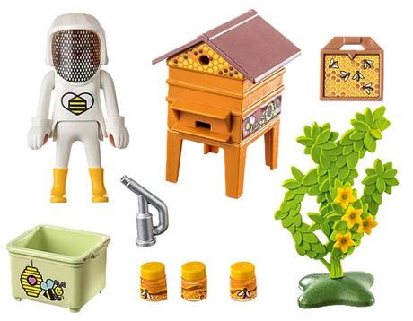 Country | Beekeeper Ali! set with beekeeper figure, beehive, honey jars, smoke blower, and flowering plant toy pieces.