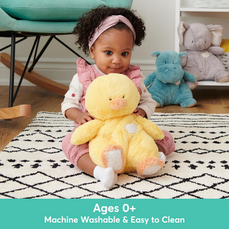 Child holding the Oh So Snuggly Duck plush toy, a yellow duck chick with quilted security blanket features.