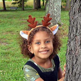 Deer Ears Headband worn by a smiling child outdoors with green grass and trees in the background.