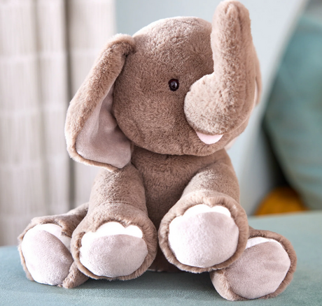Elephant Chai plush toy sitting upright with soft gray fur and a friendly, smiling face.